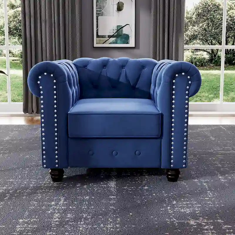 Poltrona Chesterfield in velluto Morden Fort, poltrona imbottita con bottoni, borchie e gambe in legno massello per soggiorno